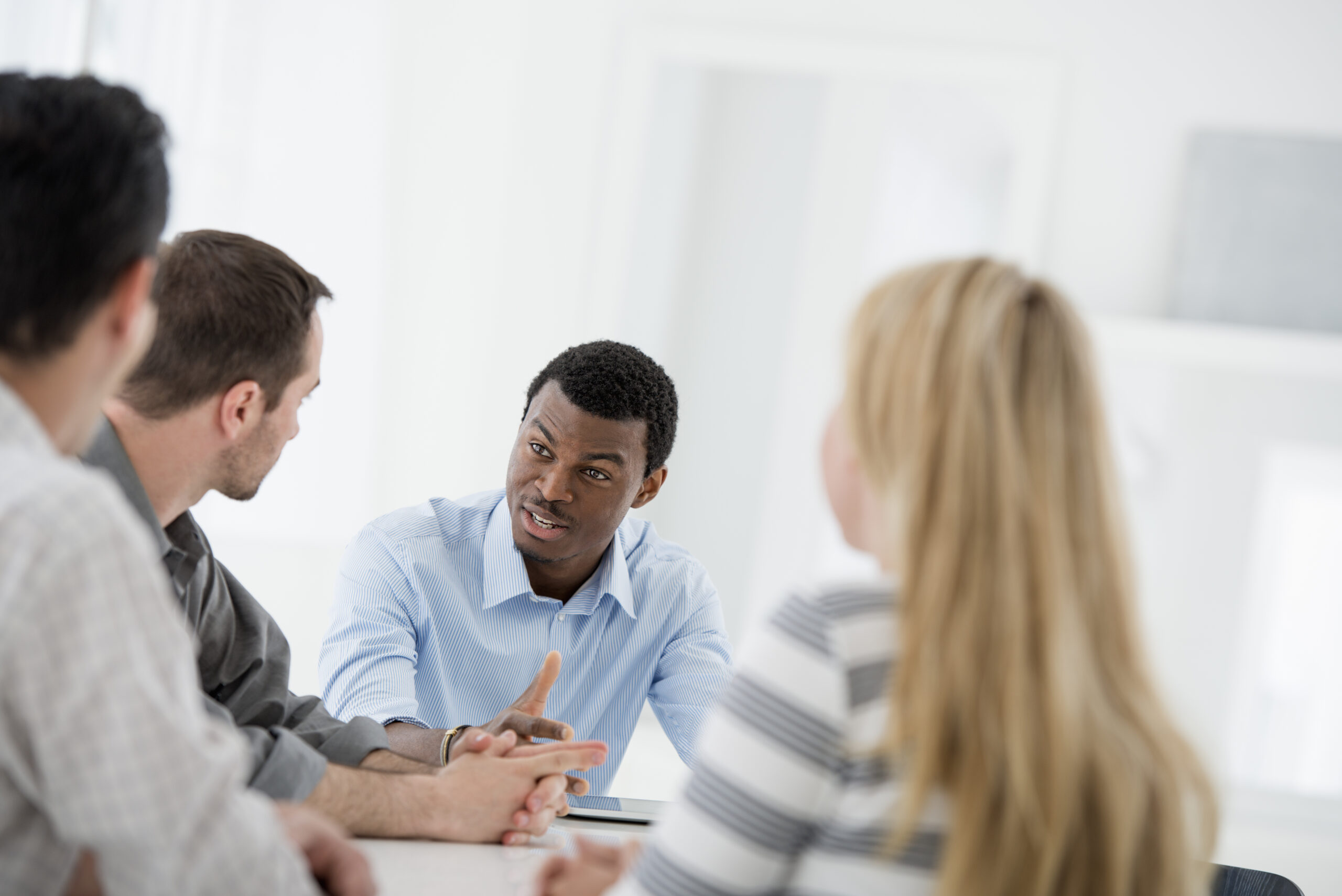 Four people discussing the terms of their mediation